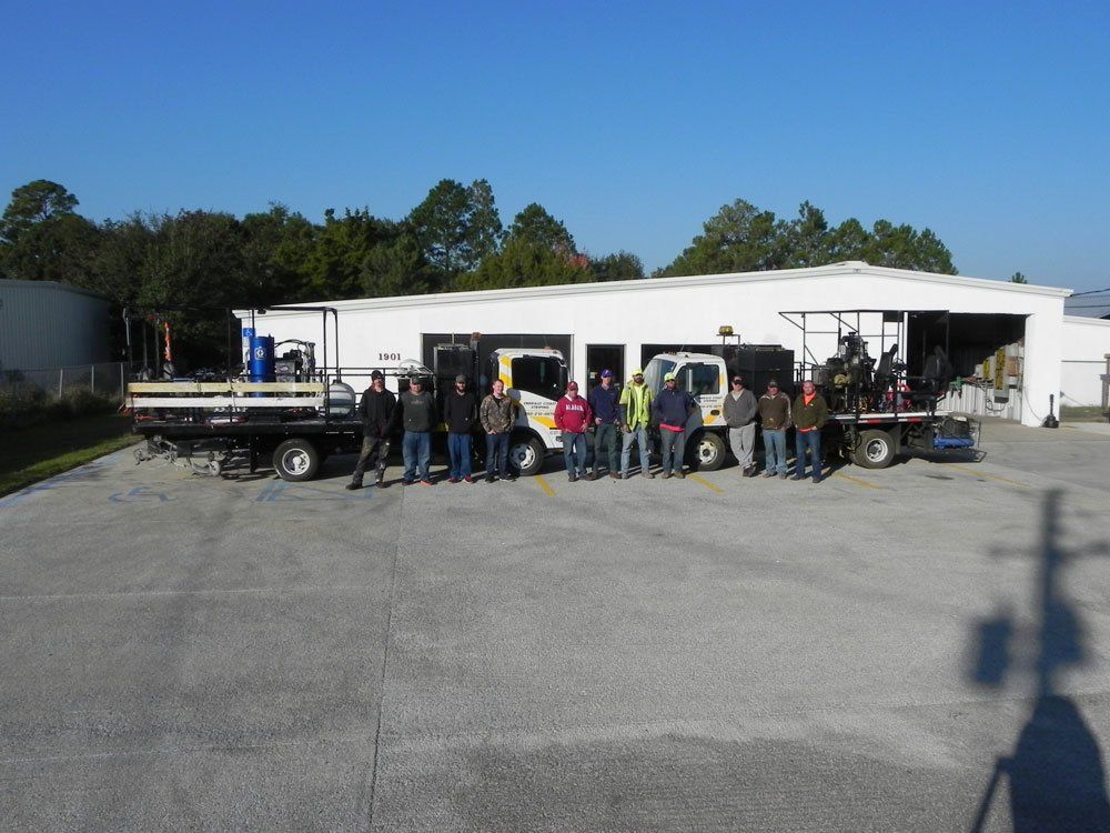 Men with Trucks Behind Them — Pensacola, FL — Emerald Coast Striping
