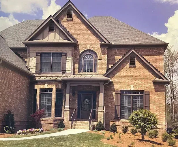 A large brick house with a gray roof