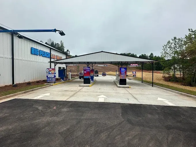 A car wash with a lot of cars parked in front of it.