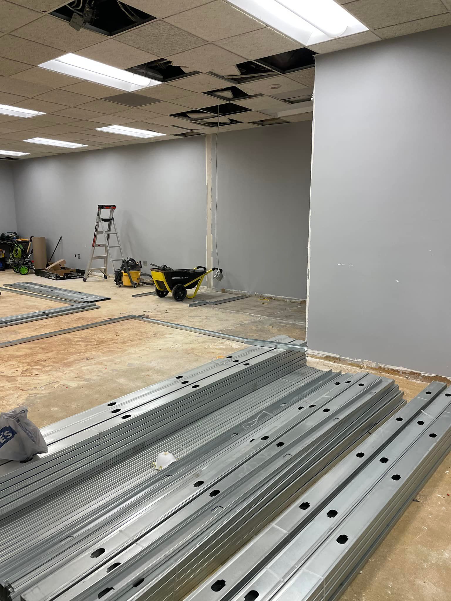 A room with a lot of metal pieces on the floor.