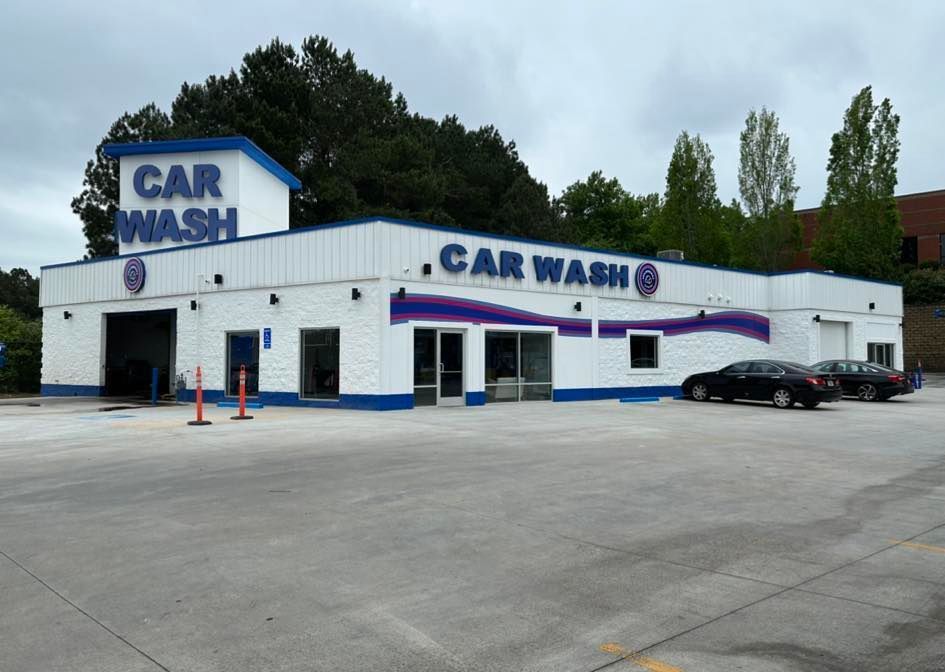 A car wash with cars parked in front of it