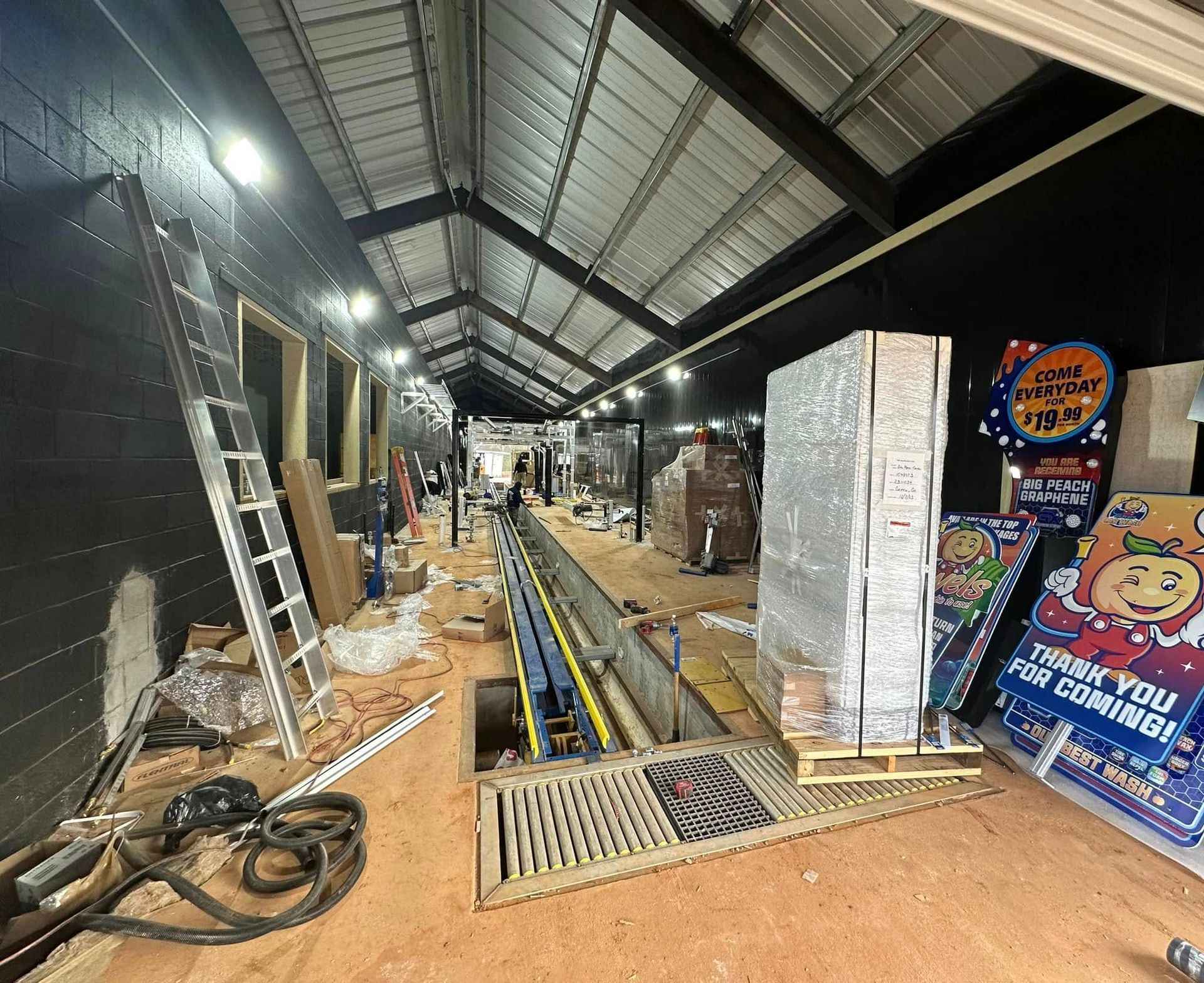 A large room with a ladder and a sign that says thank you for coming.