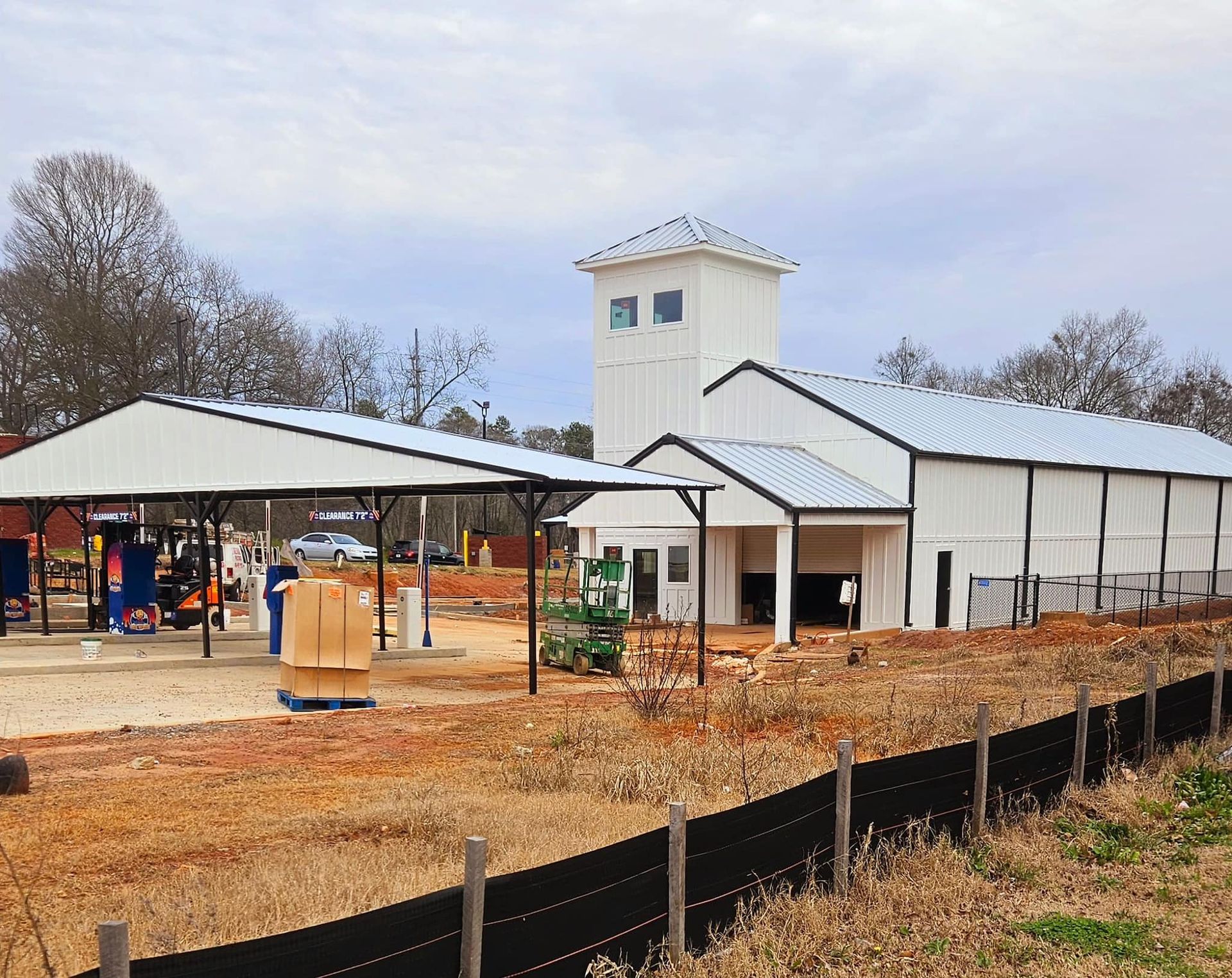 A large white building with a black fence in front of it