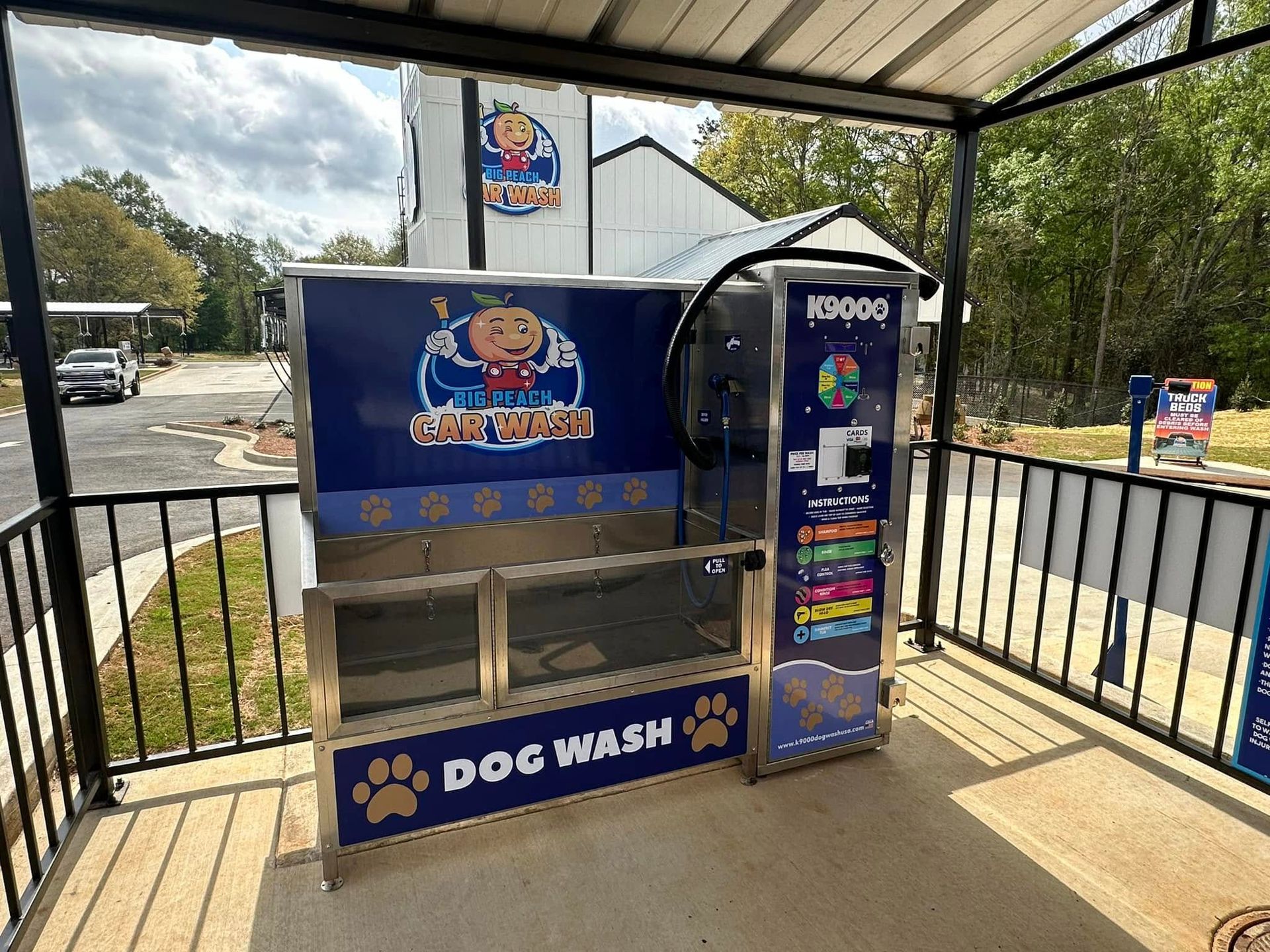A dog wash machine is sitting outside of a building.
