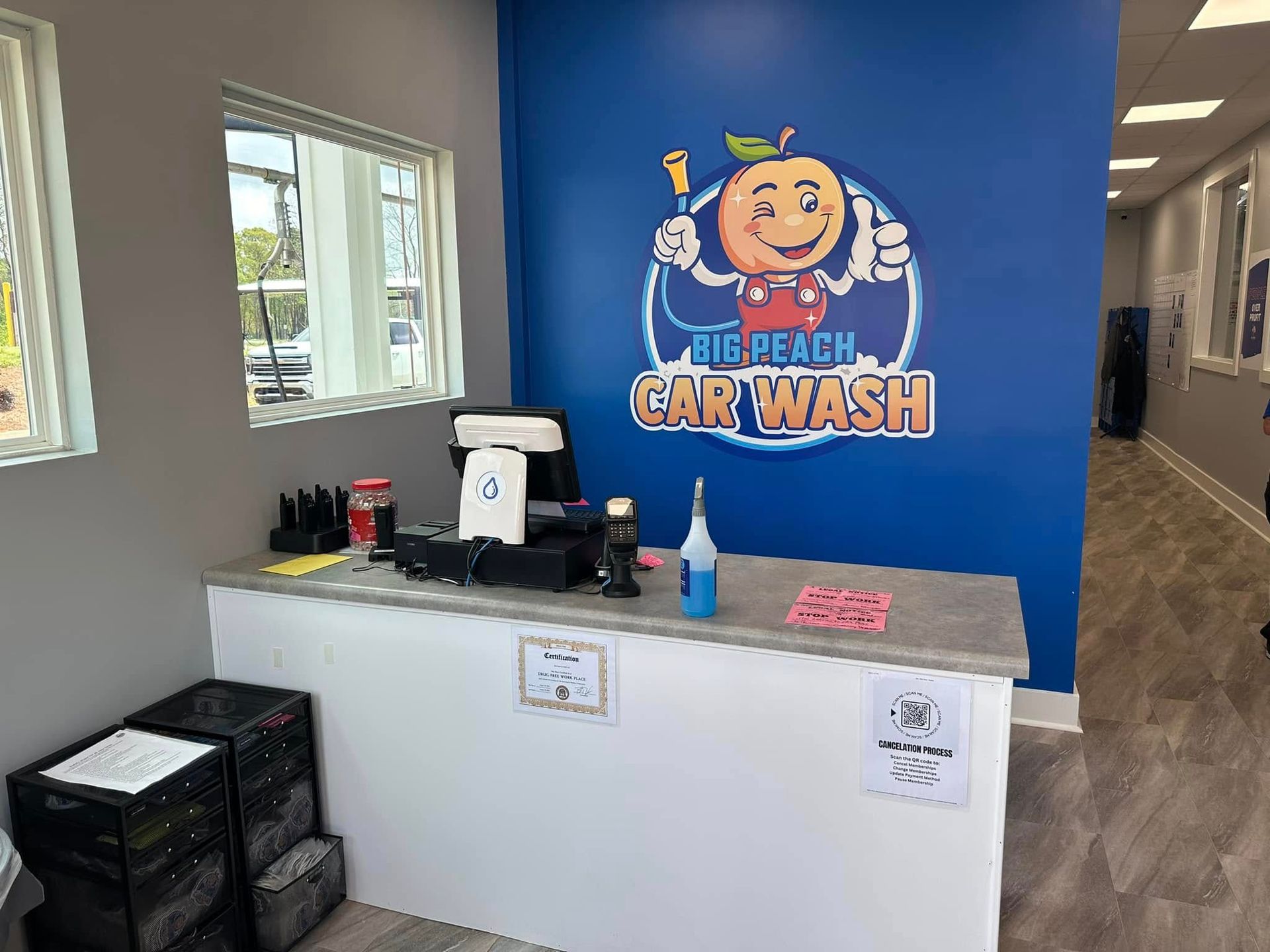 The inside of a car wash with a blue wall and a counter.