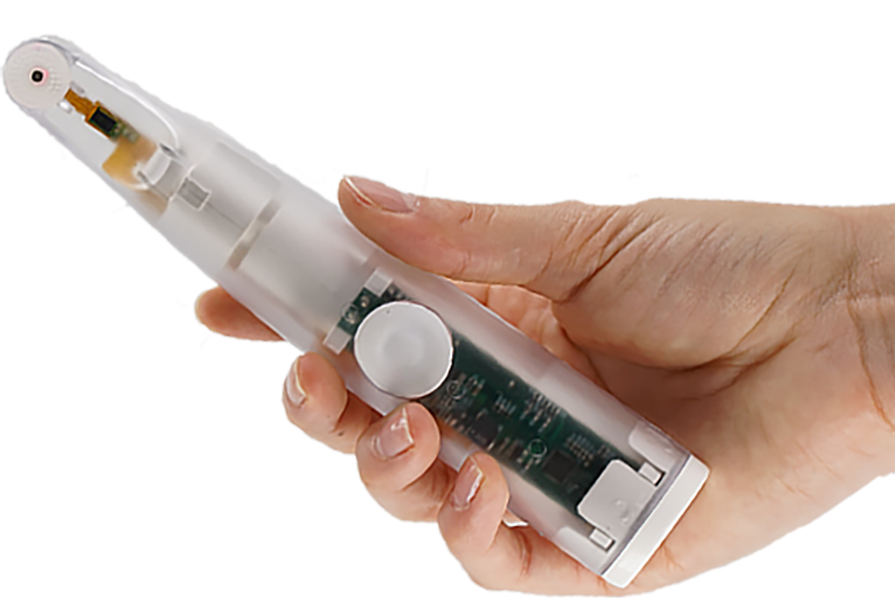 Hand holding a transparent white device with internal circuitry; a button and tip are visible.