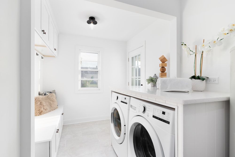 A Laundry Room With Two Washers and Two Dryers — R.K. Plumbing & Gas In Bli Bli, QLD