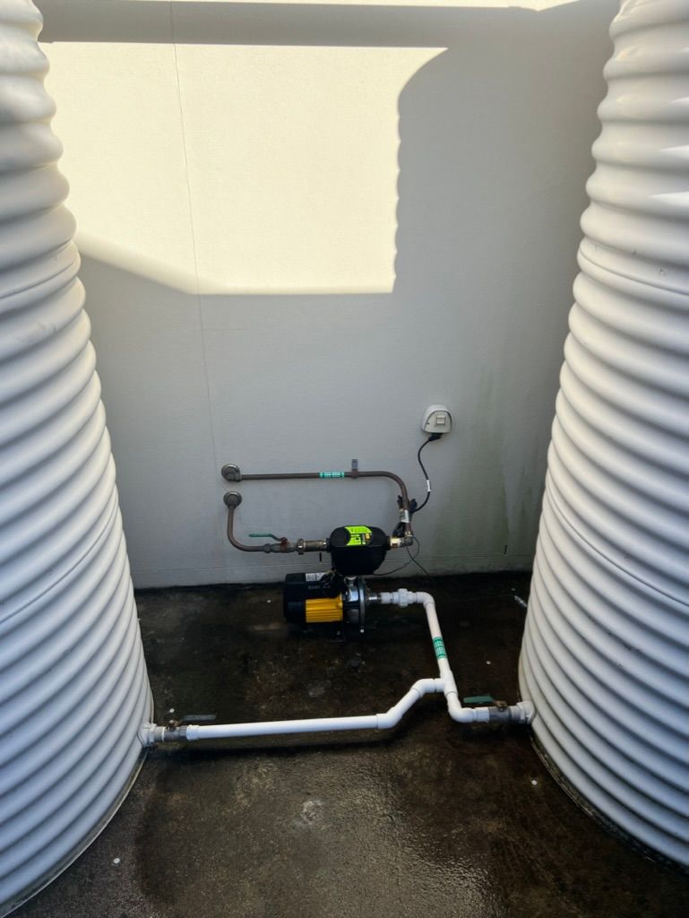 Two White Water Tanks Are Sitting Next to Each Other in a Room — R.K. Plumbing & Gas In Bli Bli, QLD