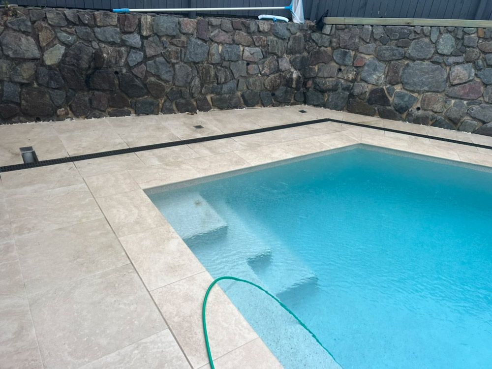 Swimming Pool With Steps and a Stone Wall — R.K. Plumbing & Gas In Bli Bli, QLD