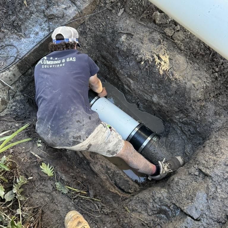 A Man is Standing in Front of a Plumbing and Gas Truck — R.K. Plumbing & Gas In Bli Bli, QLD