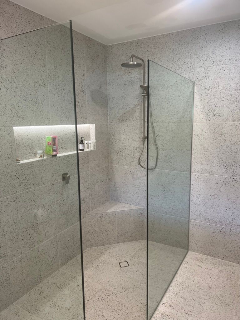 A Walk in Shower With a Glass Door and a Shower Head — R.K. Plumbing & Gas In Bli Bli, QLD
