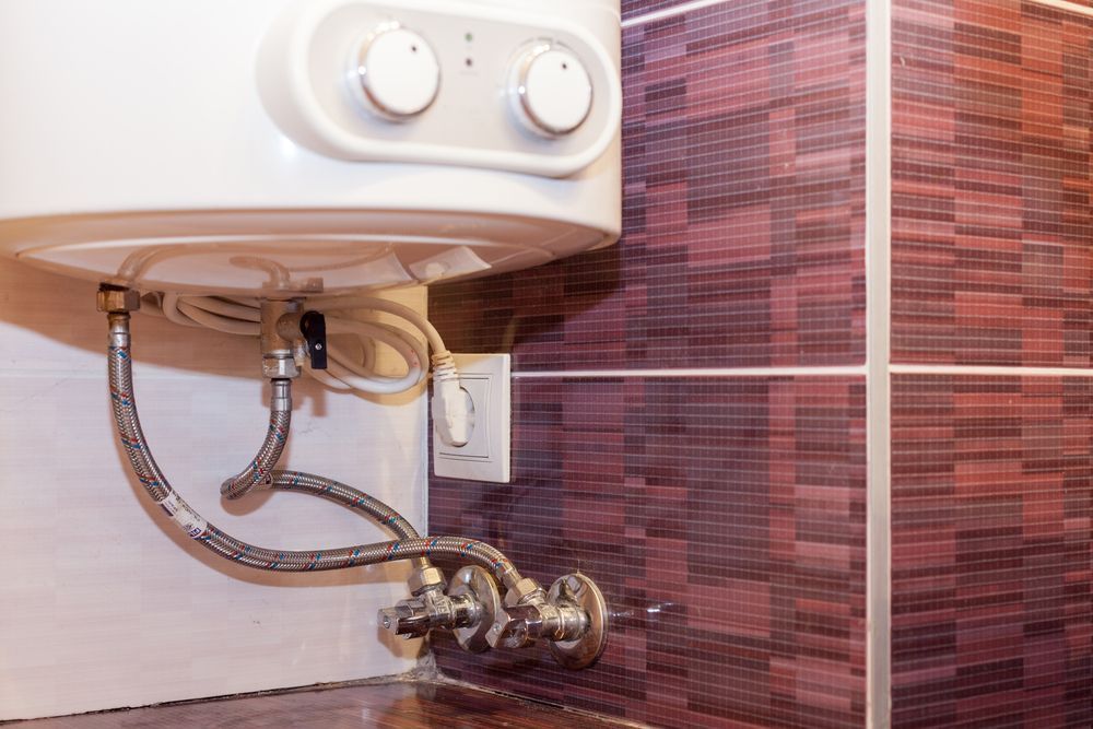A Water Heater is Attached to a Wall in a Bathroom — R.K. Plumbing & Gas In Bli Bli, QLD