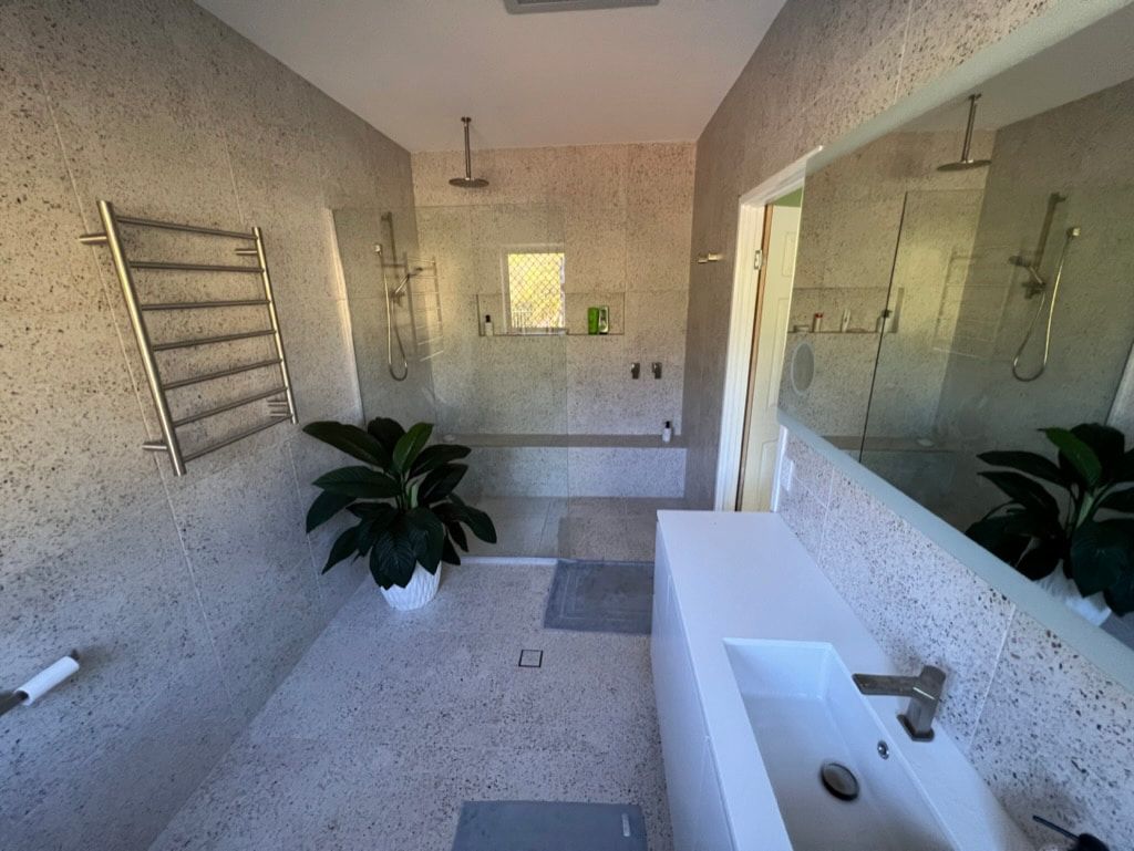 A Bathroom With a Sink , Shower , and Mirror — R.K. Plumbing & Gas In Bli Bli, QLD