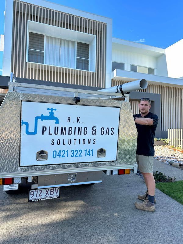 A Man Standing Next to a Plumbing and Gas Solutions Truck — R.K. Plumbing & Gas In Bli Bli, QLD