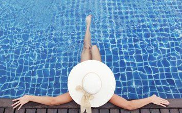 Woman in hat relaxing at Pool—Pool Store in Manorville, NY