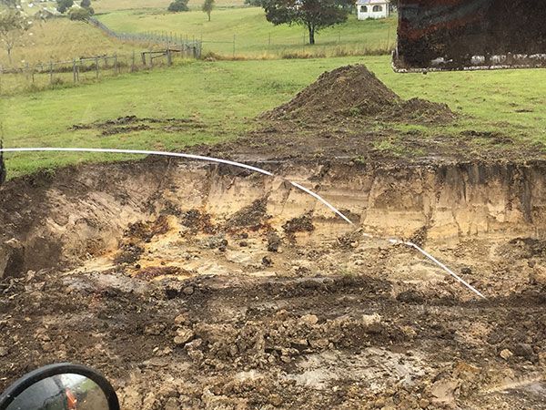 A large pile of dirt is sitting in the middle of a field.