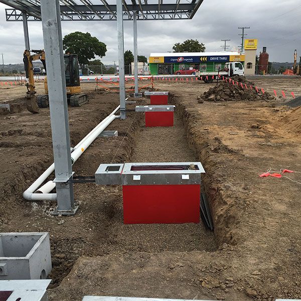 A construction site with red boxes in the dirt