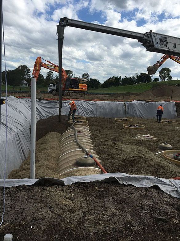 A construction site with a crane and a hose.