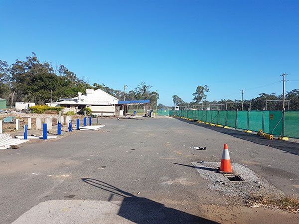 An empty parking lot with a cone in the middle of it