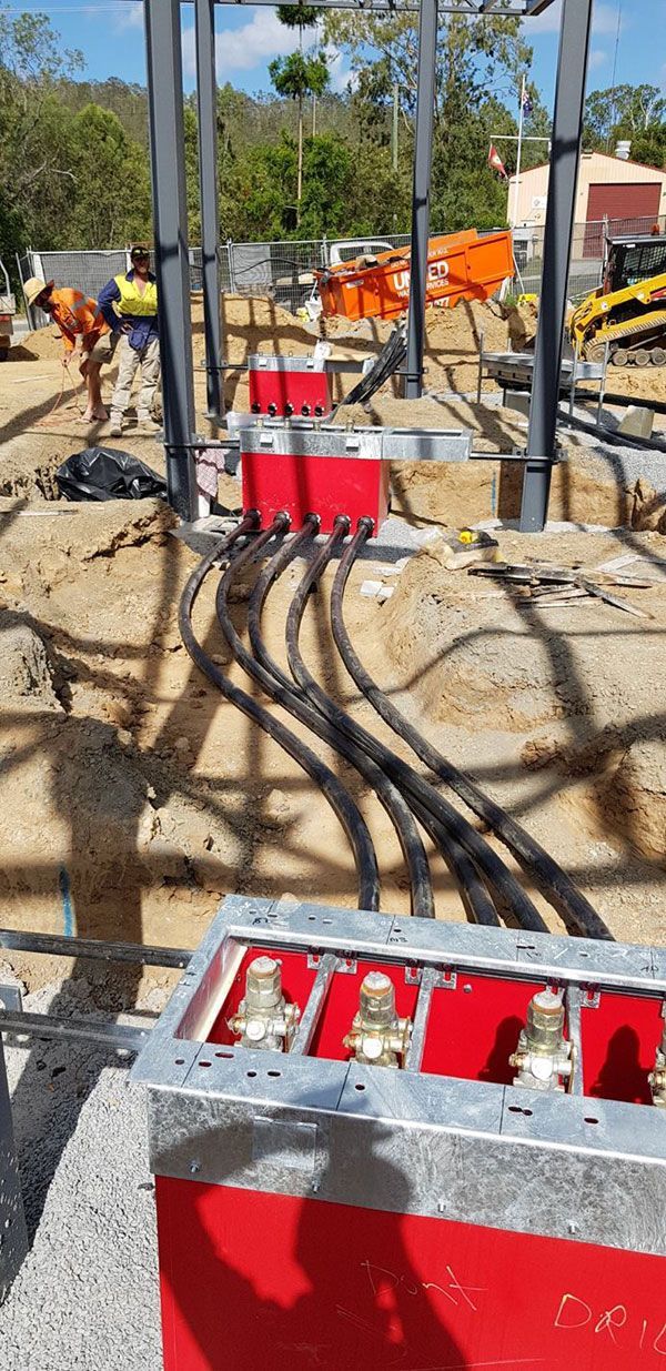 A construction site with a lot of wires coming out of the ground.