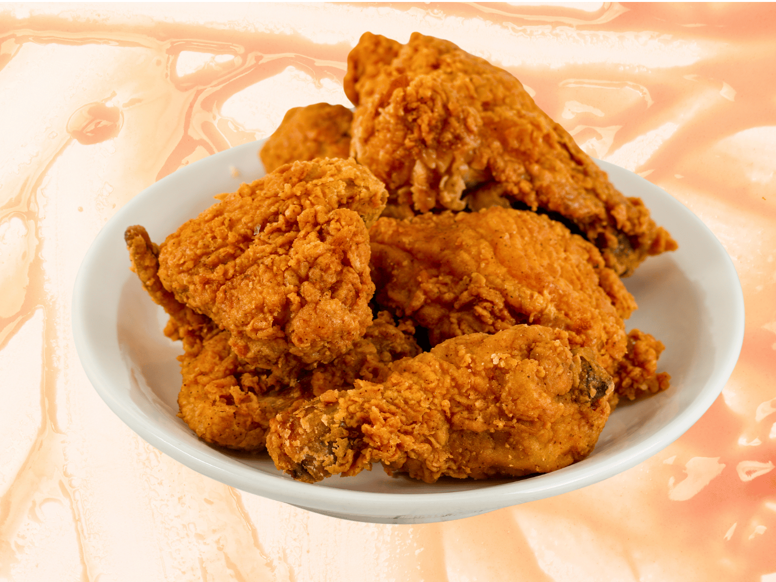 A white plate topped with fried chicken wings