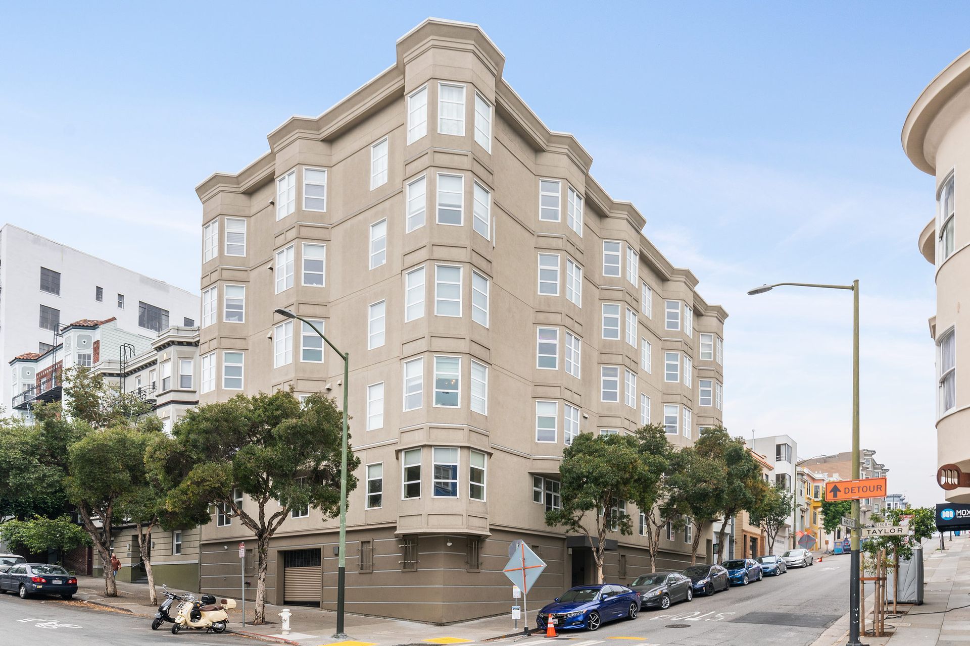 1101 Pacific Ave - a large building with a lot of windows is on the corner of a street .