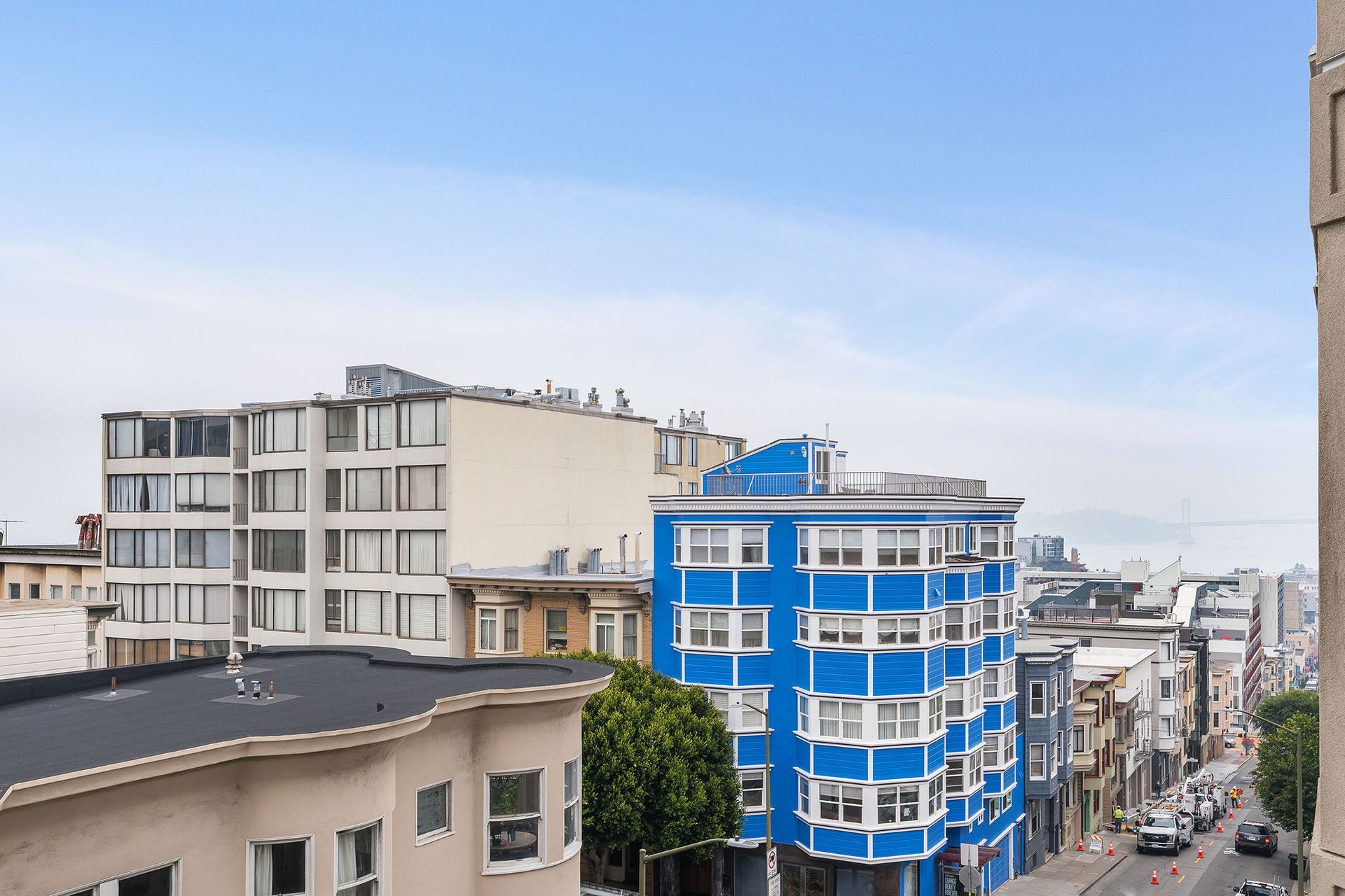 1101 Pacific Ave- a view of a city street with a blue building in the foreground .