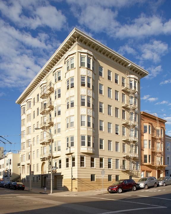 2300 Webster- a large building with a lot of windows and cars parked in front of it