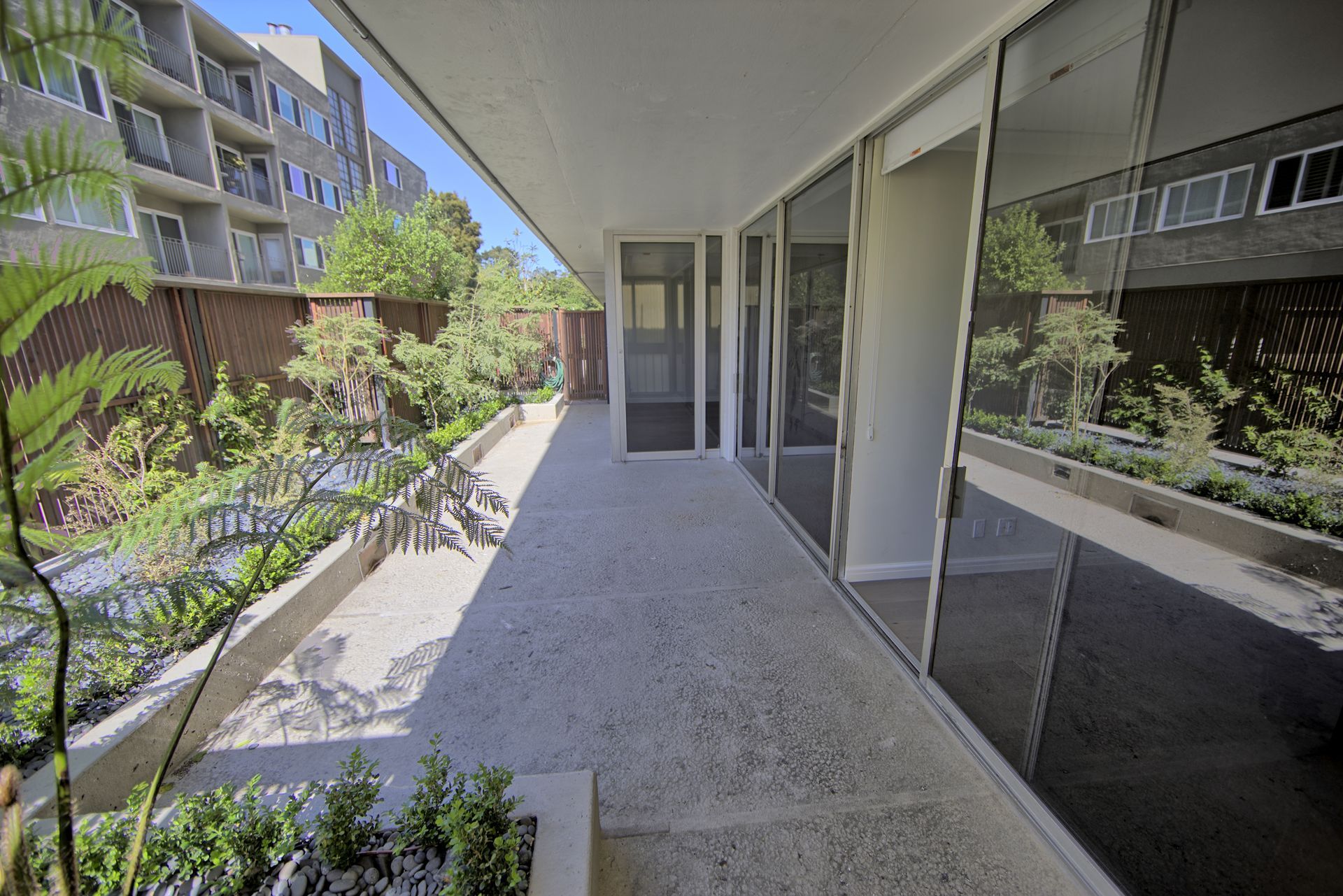 3535 Fillmore- a building with a lot of windows and a walkway leading to it