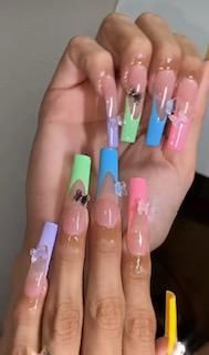 A close up of a person 's nails with different colors.