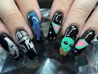 A close up of a person 's nails with a star wars design on them.