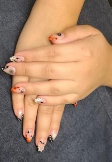 A close up of a person 's hands with halloween nails