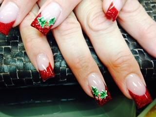A close up of a woman 's nails with a red french manicure