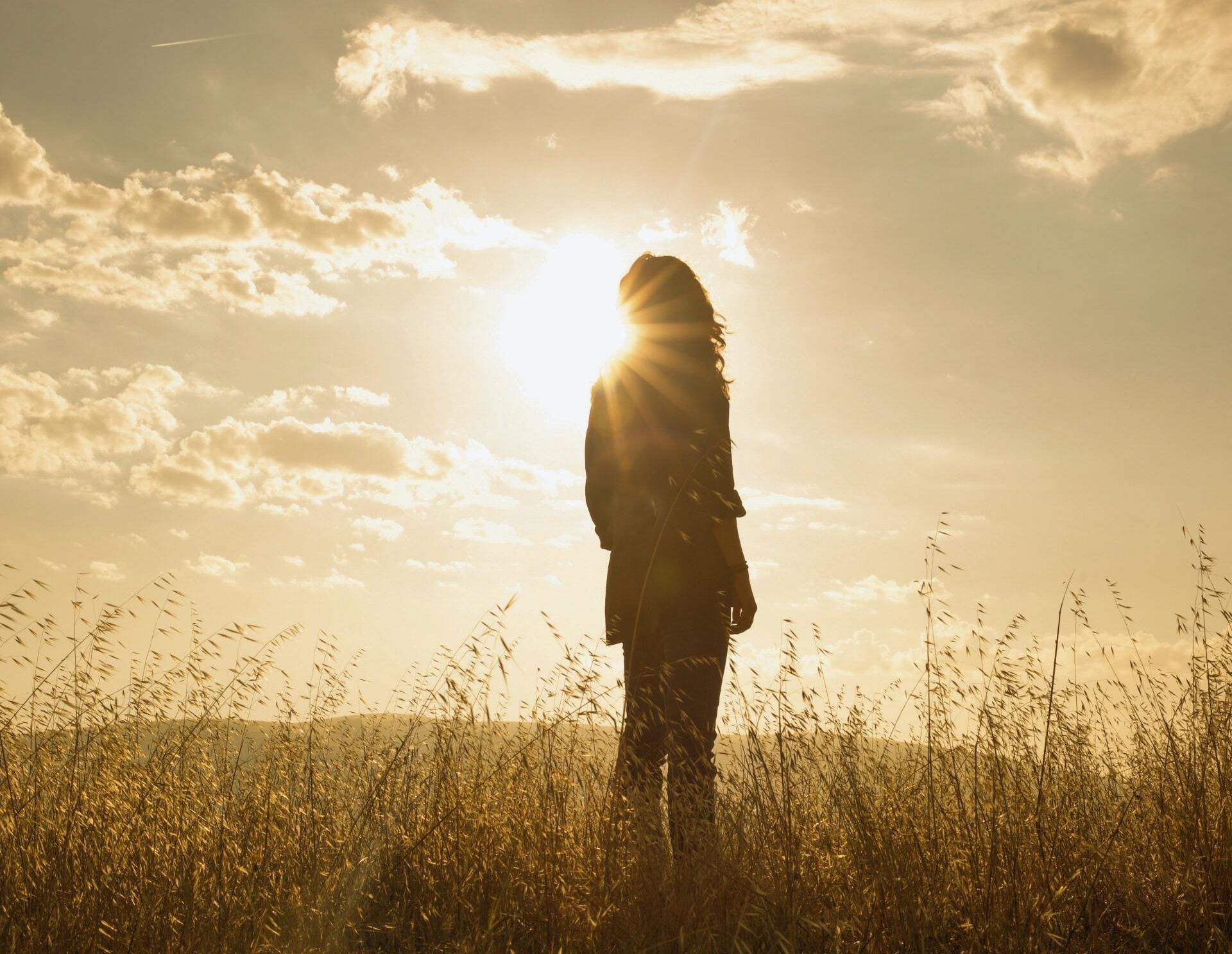 Person with Long Blonde Hair and a Sunset