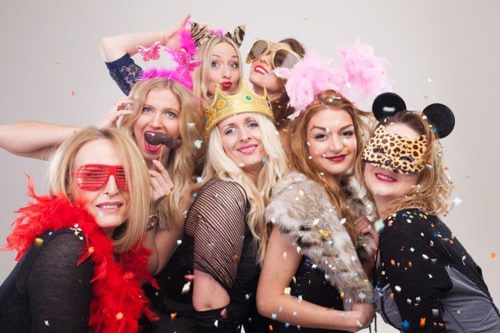Women posing in a corporate photo booth.
