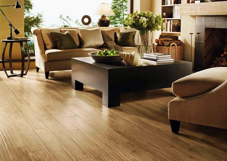 A living room with a couch a chair a coffee table and a fireplace