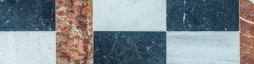 A close up of a marble floor with a checkered pattern.