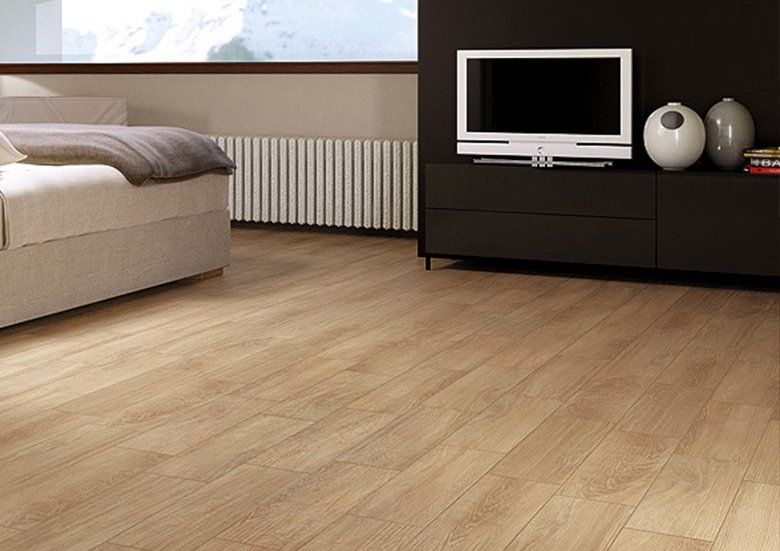 A bedroom with hardwood floors and a flat screen tv