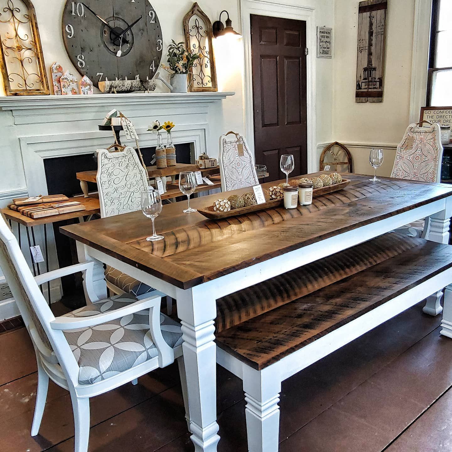 A dining room with a table and chairs and a clock that says 10 on it