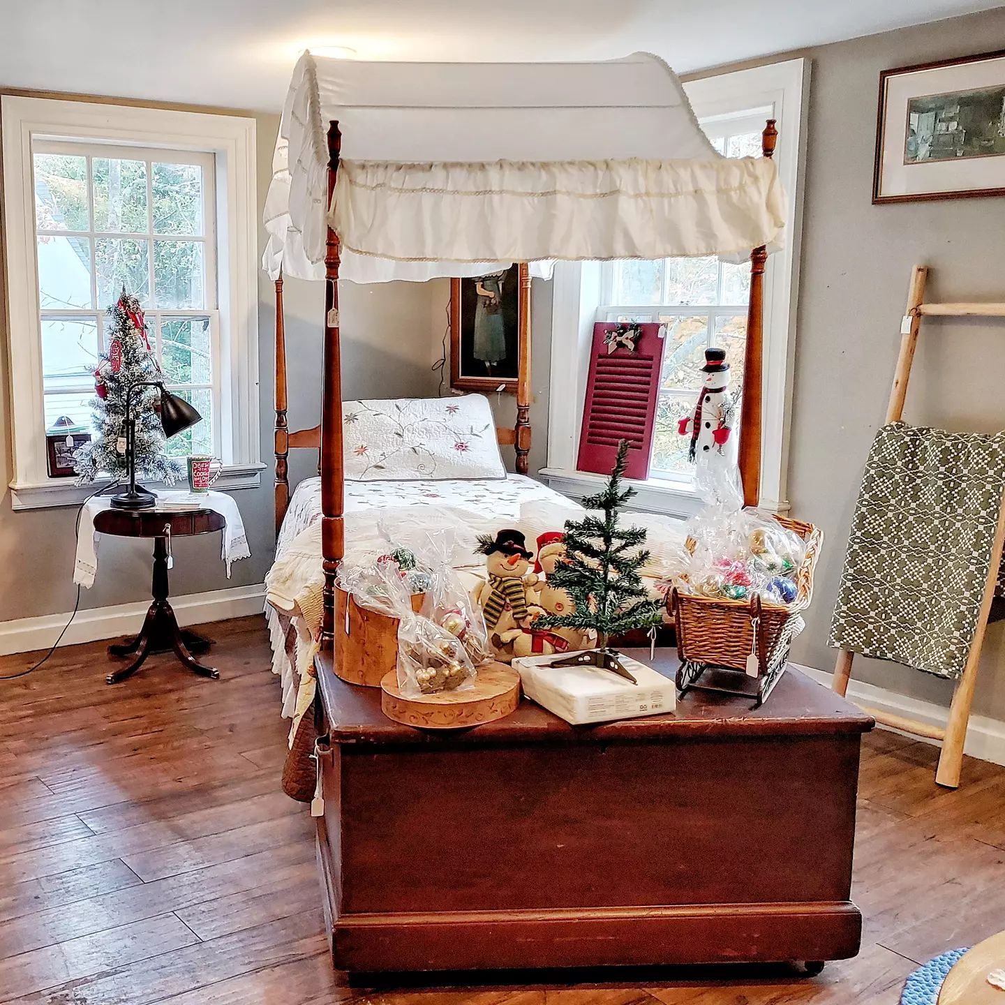 A bedroom with a canopy bed and a christmas tree