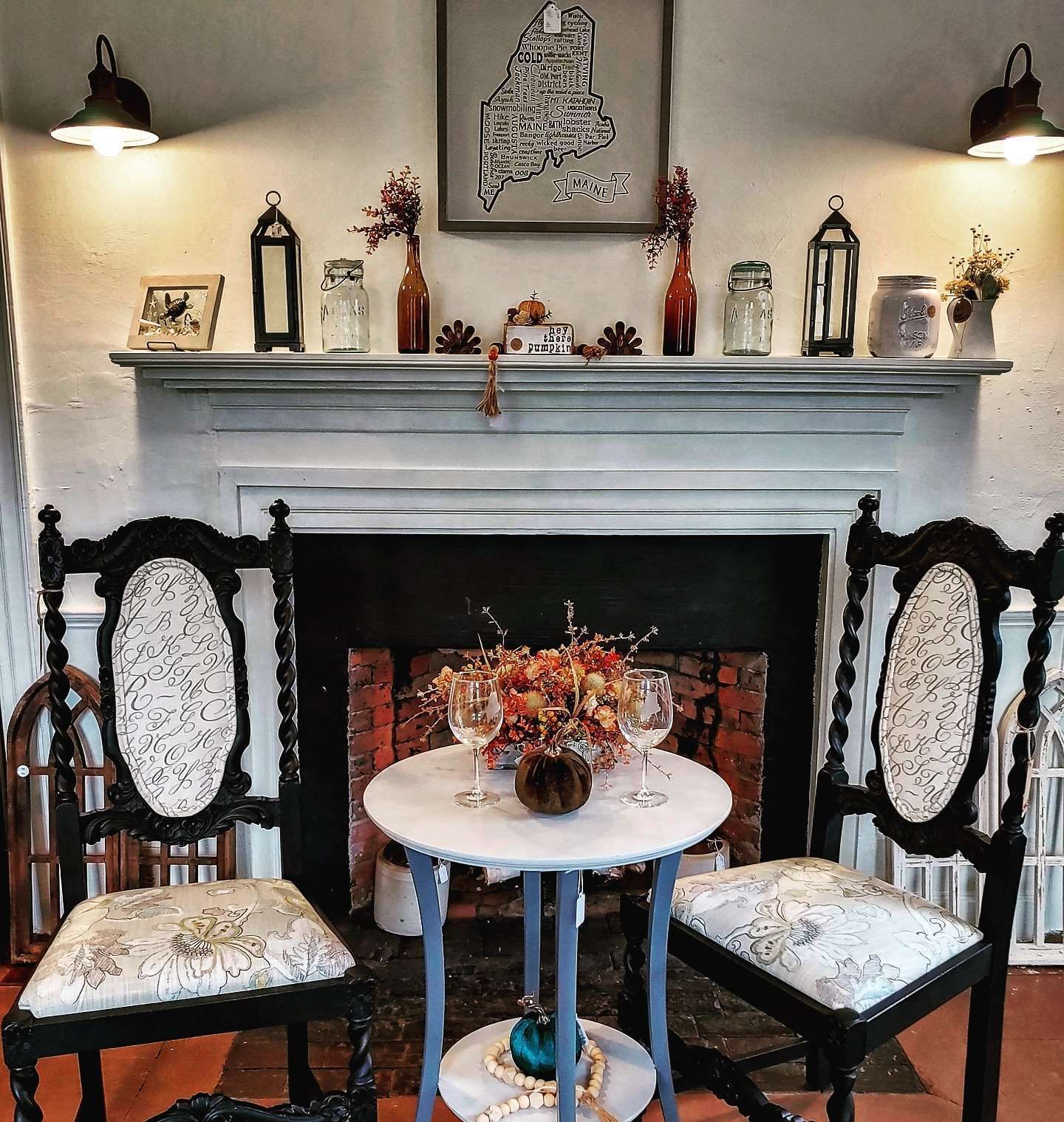A fireplace with a table and chairs in front of it
