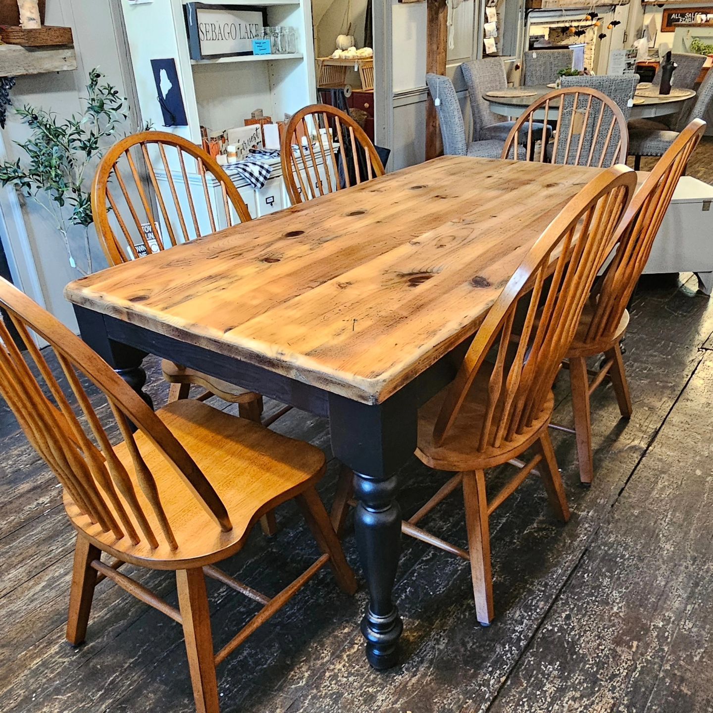 A wooden table with wooden chairs around it in a room