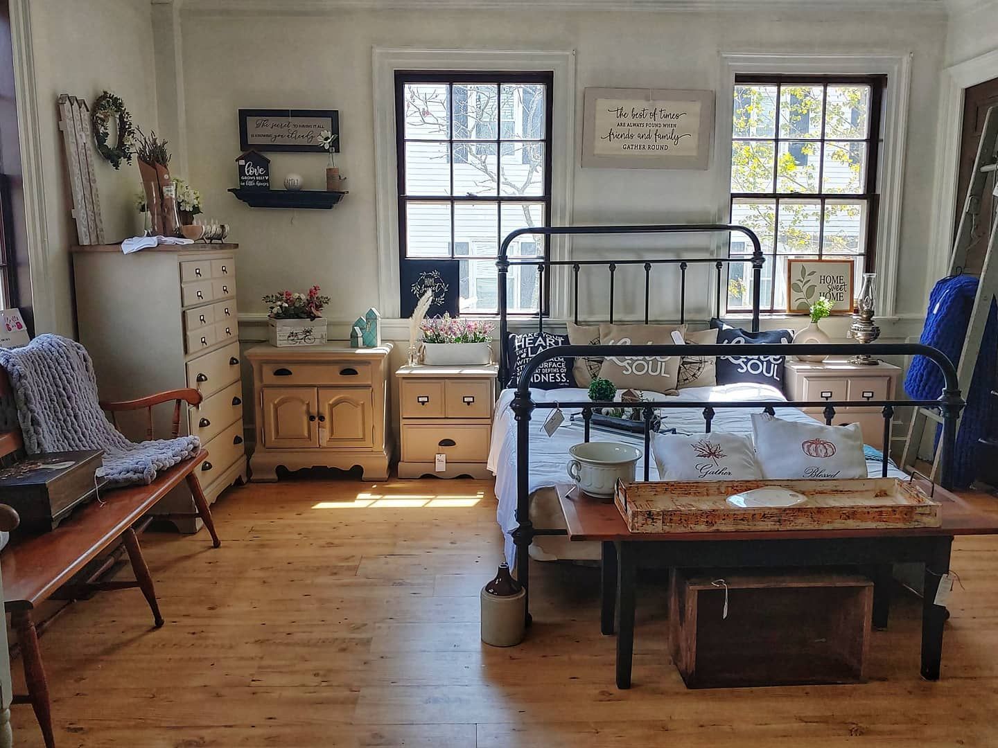 A bedroom with a bed , dresser , nightstand and chair.