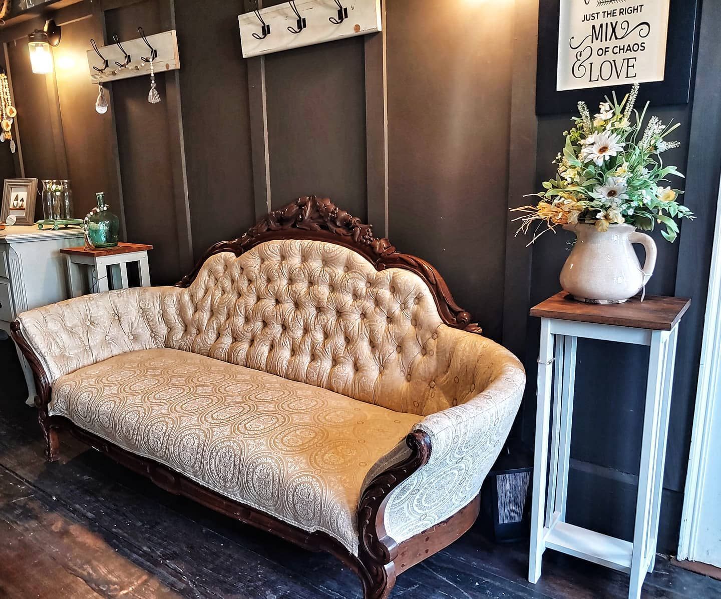 A couch in a room with a sign on the wall that says miss