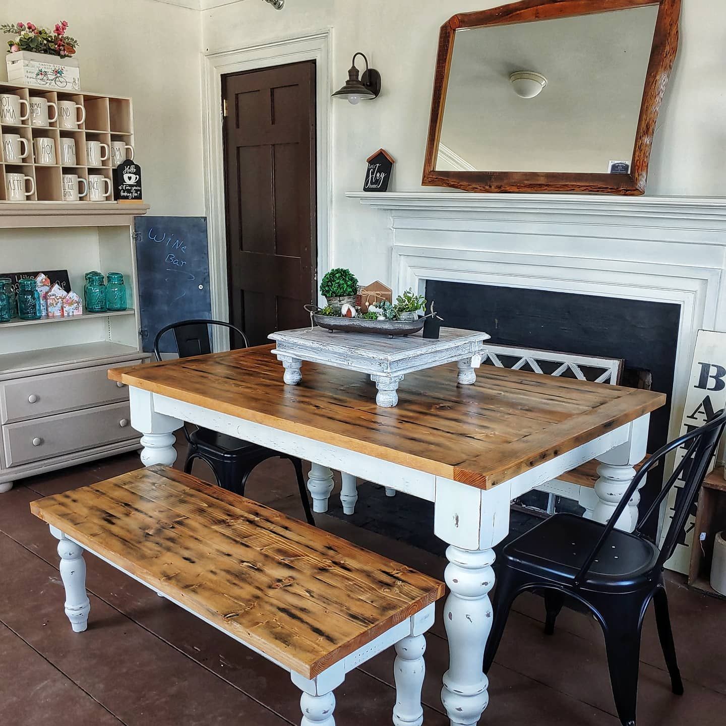 A dining room table with a bench and chairs