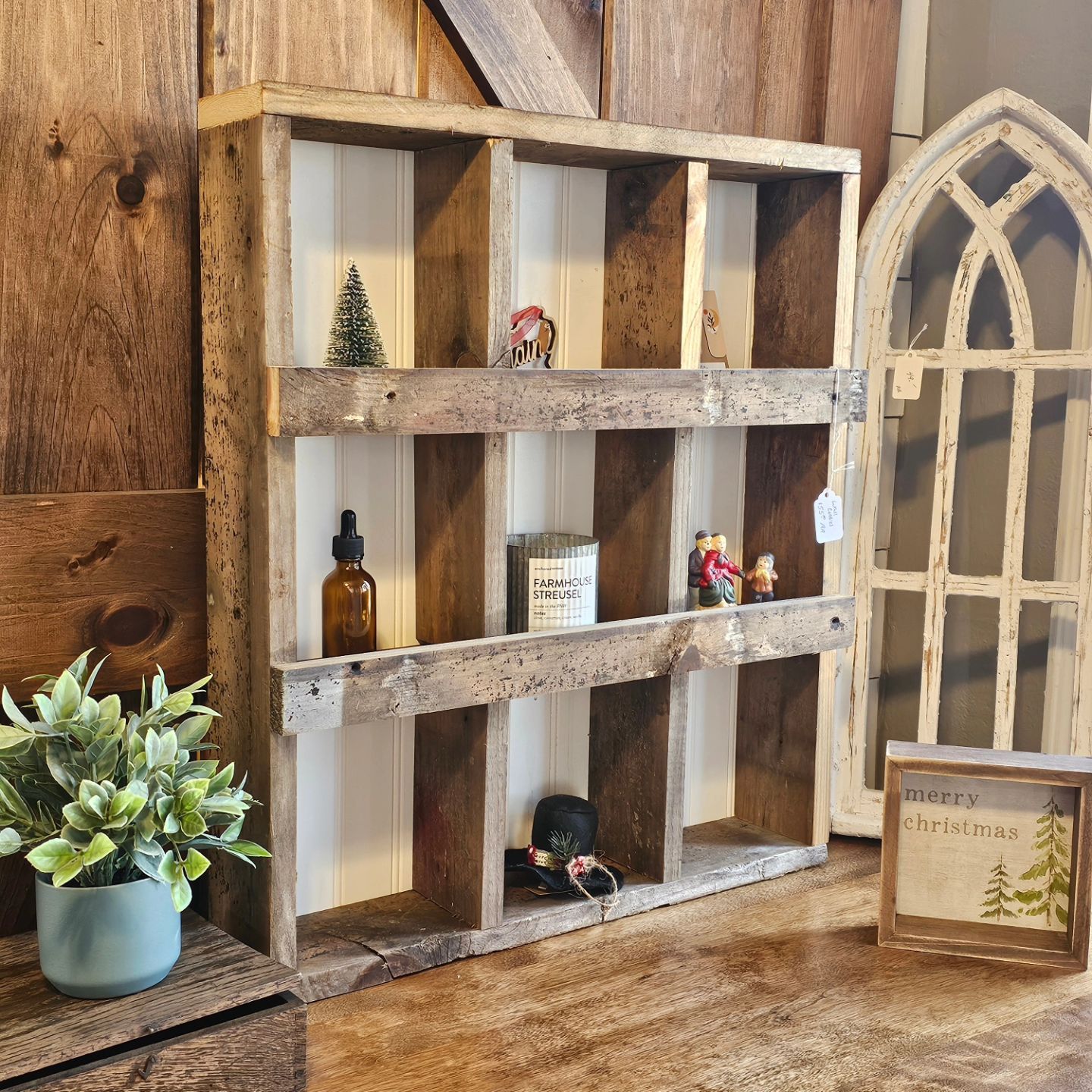 A wooden shelf with a sign that says ' christmas ' on it