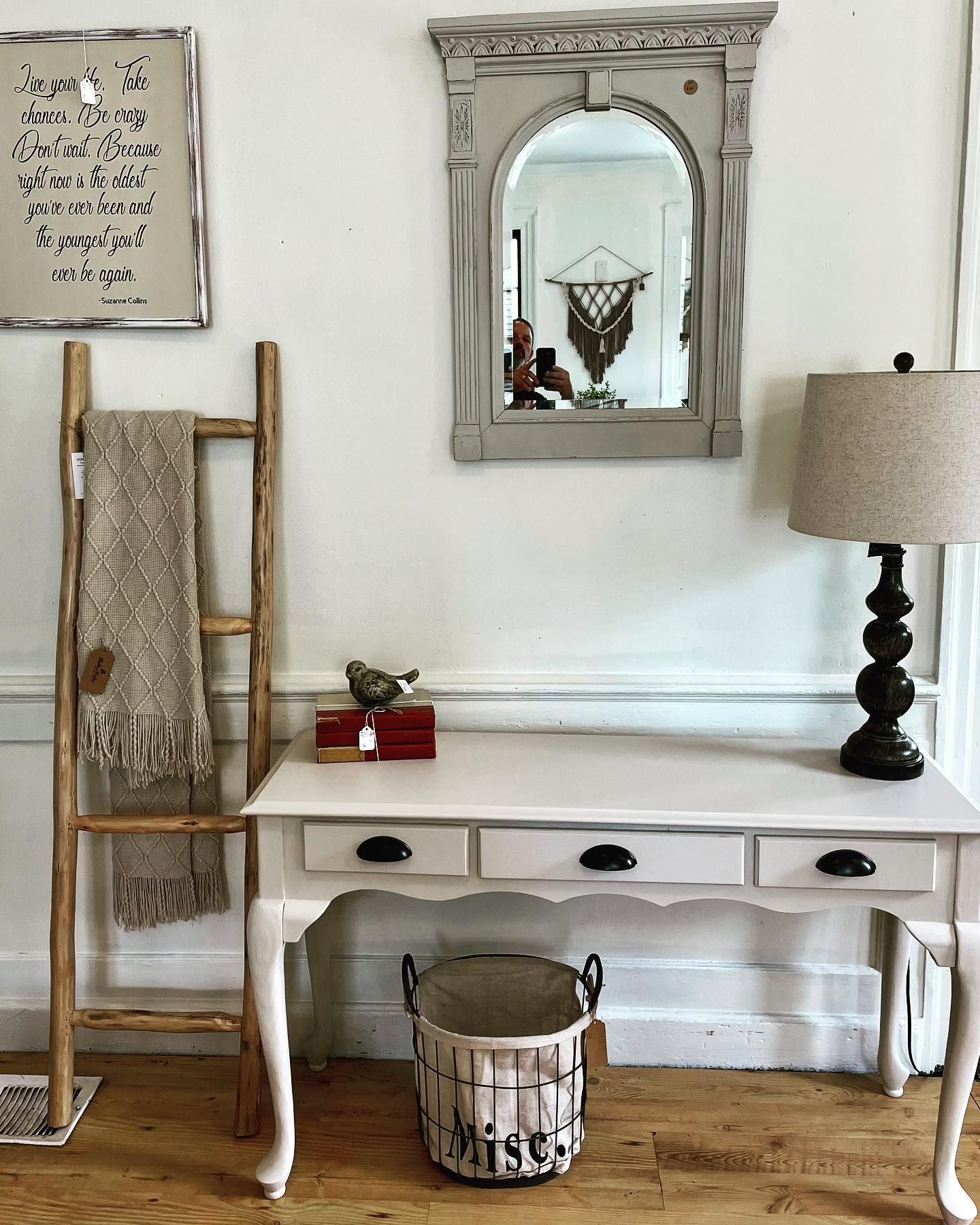 A white desk with a lamp and a basket on it