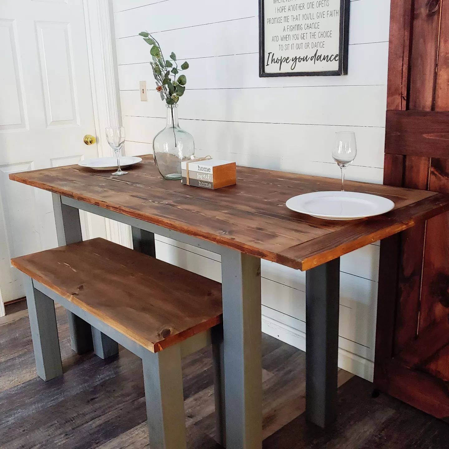 A wooden table with two benches and plates on it