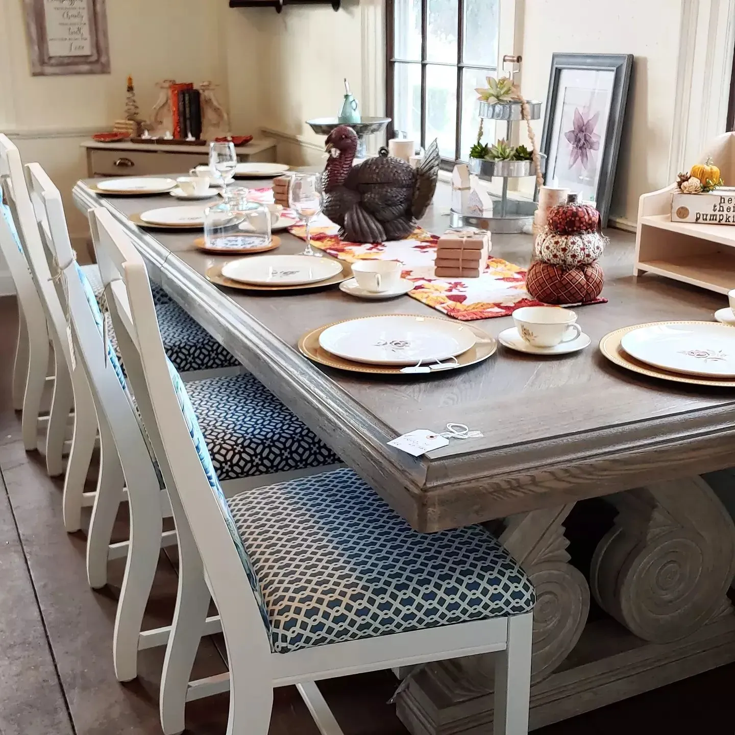 A long table with plates and a turkey on it