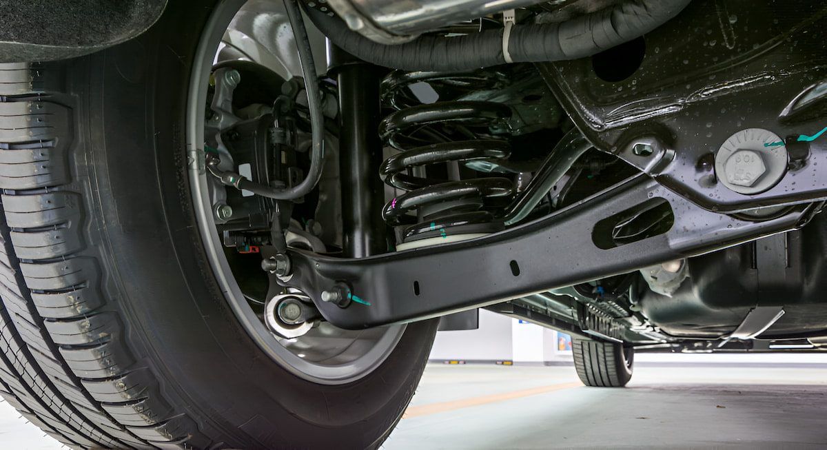 A Close Up Of The Underside Of A Car With A Tire And Suspension — Cameron Brothers Automotive In Currajong, QLD